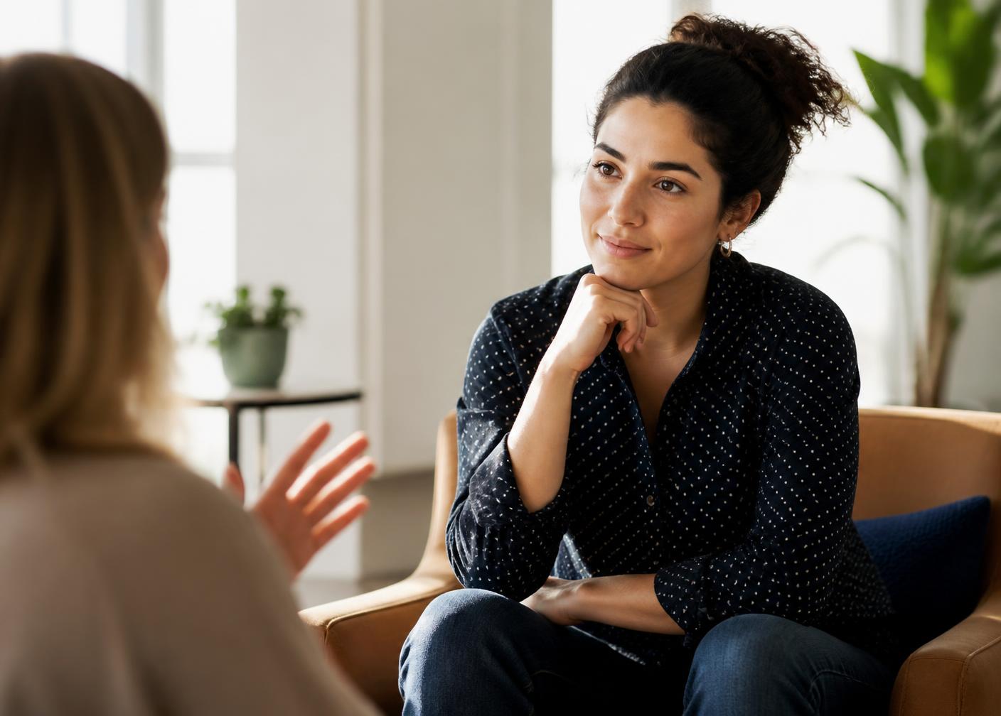 A candidate and a recruitment consultant talking in a bright, sunlit office